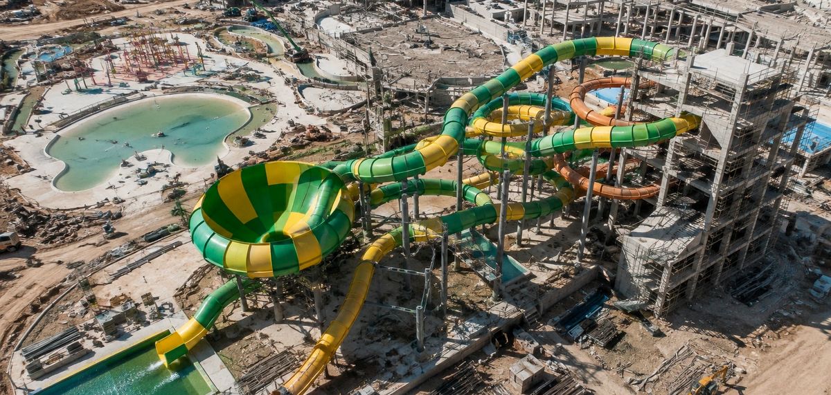 Aerial view of a water park under construction in an arid desert setting